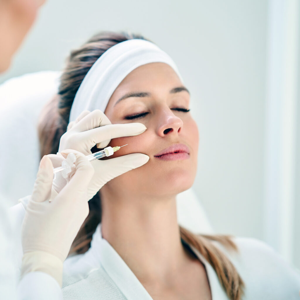 Woman getting injectable treatment on her face